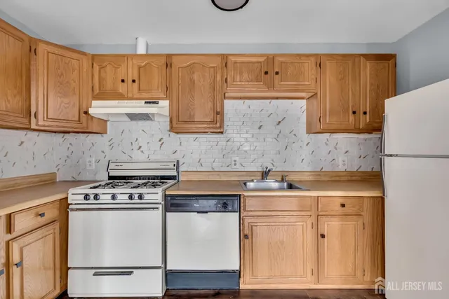 a kitchen with stainless steel appliances granite countertop a stove and a refrigerator