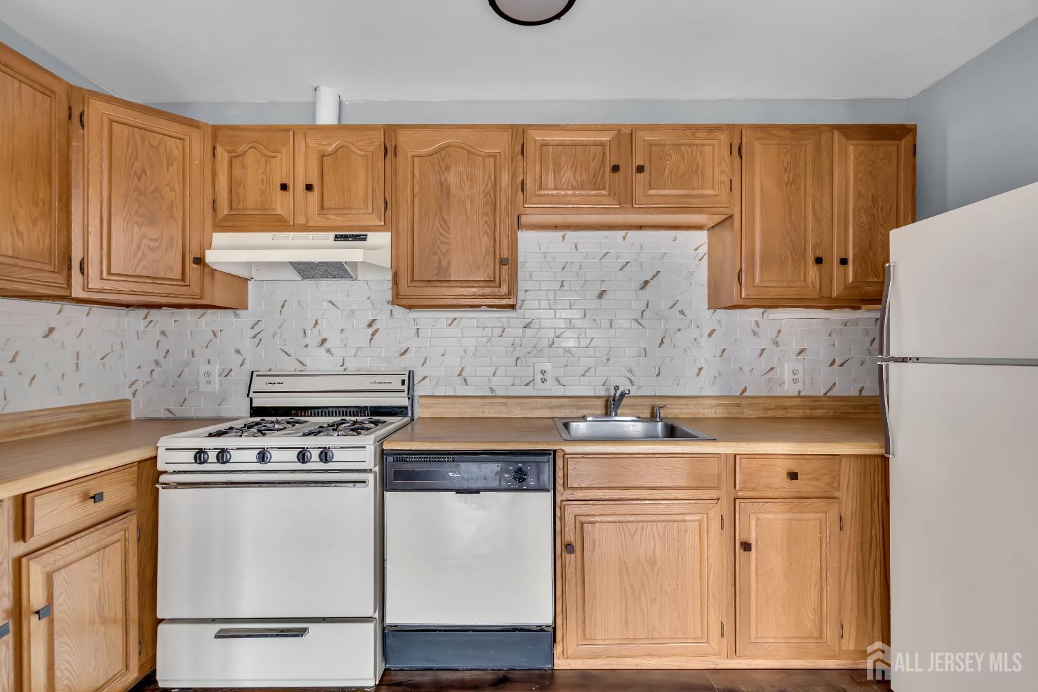 a kitchen with stainless steel appliances granite countertop a stove and a refrigerator