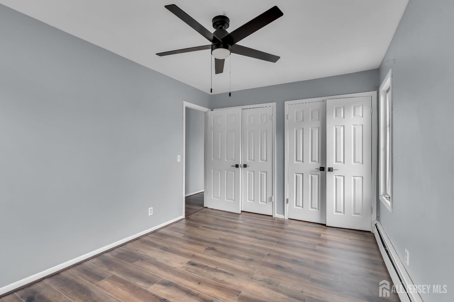 1595 East 2nd Street, Unit 2 Scotch Plains, NJ 07076 - Photo 11 of 13 a view of room with hardwood floor and a ceiling fan
