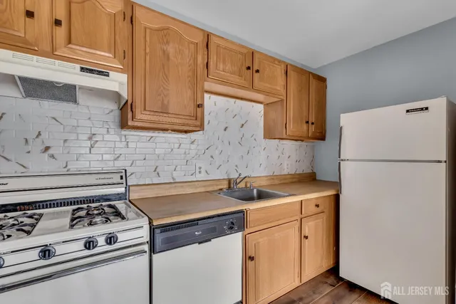 a kitchen with a stove and a refrigerator