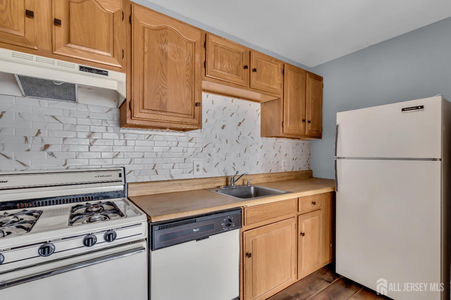 1595 East 2nd Street, Unit 2 Scotch Plains, NJ 07076 - Photo 3 of 13 a kitchen with a stove and a refrigerator