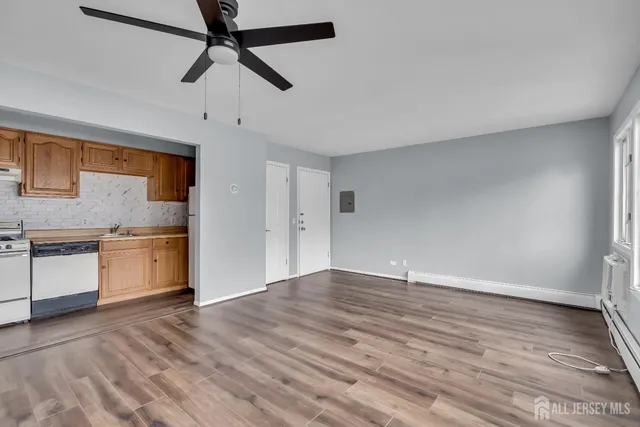 a view of a kitchen with a sink dishwasher stove and cabinets