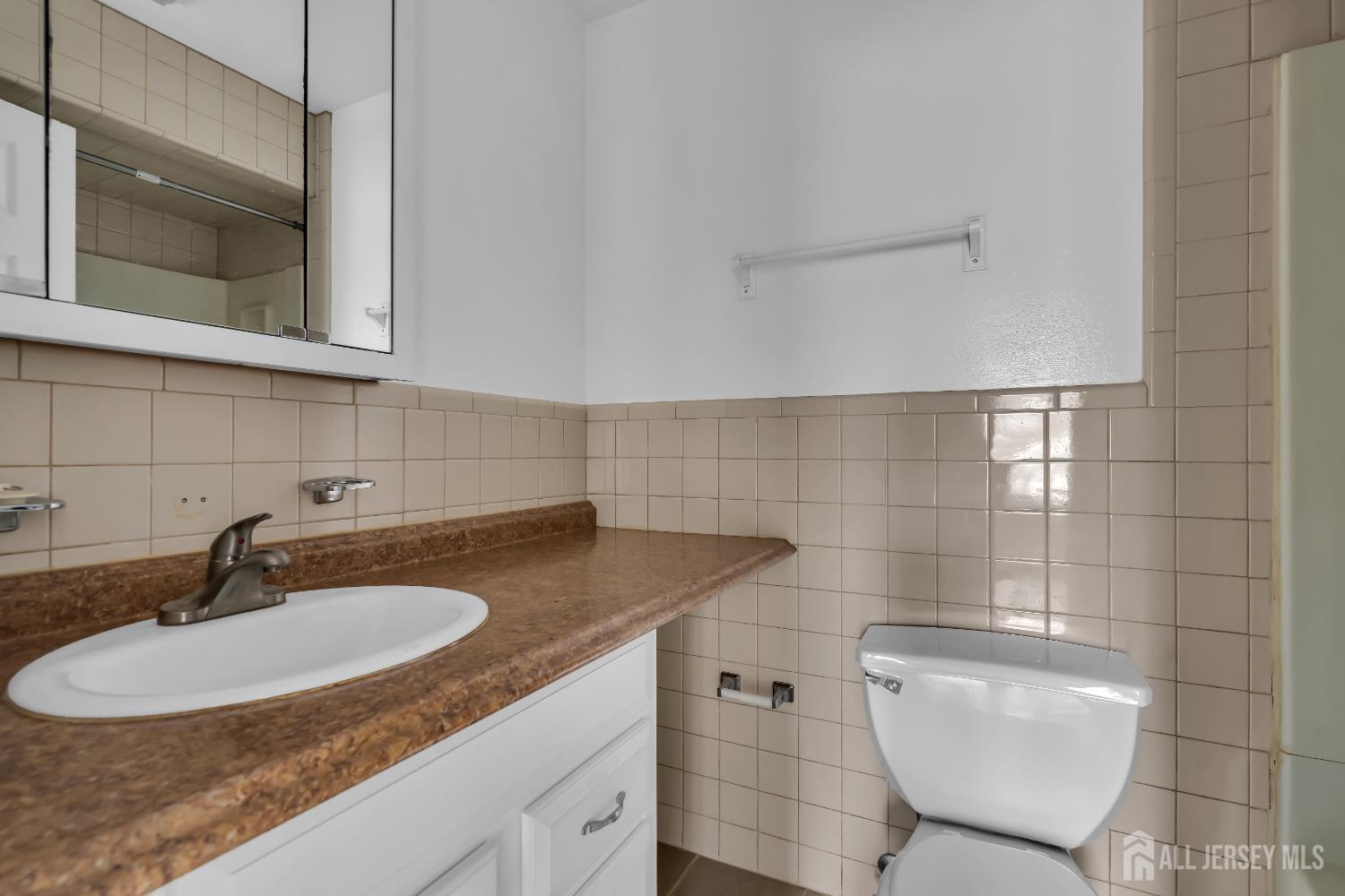 1595 East 2nd Street, Unit 2 Scotch Plains, NJ 07076 - Photo 8 of 13 a bathroom with a sink and a mirror