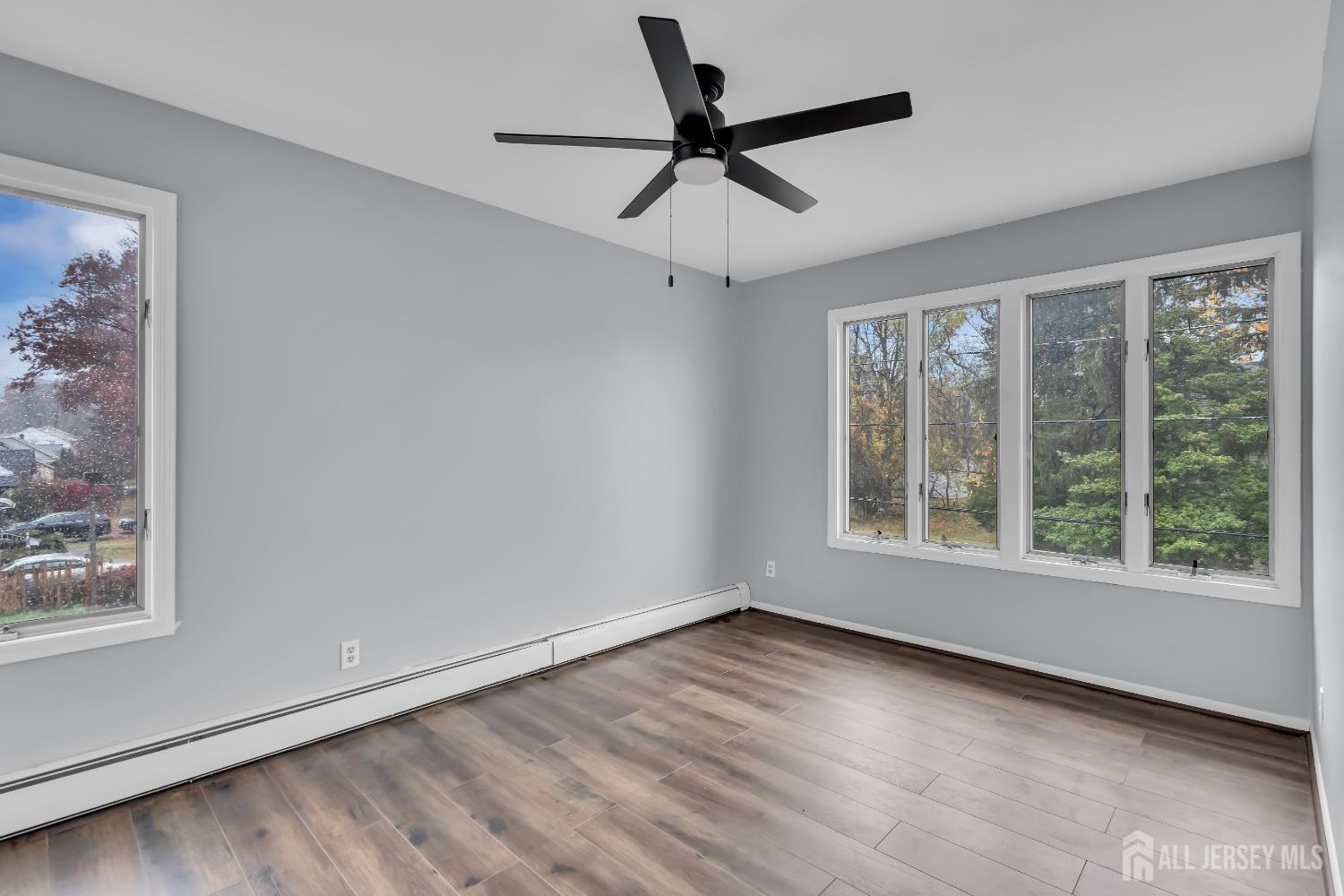 1595 East 2nd Street, Unit 2 Scotch Plains, NJ 07076 - Photo 10 of 13 wooden floor in an empty room with a window