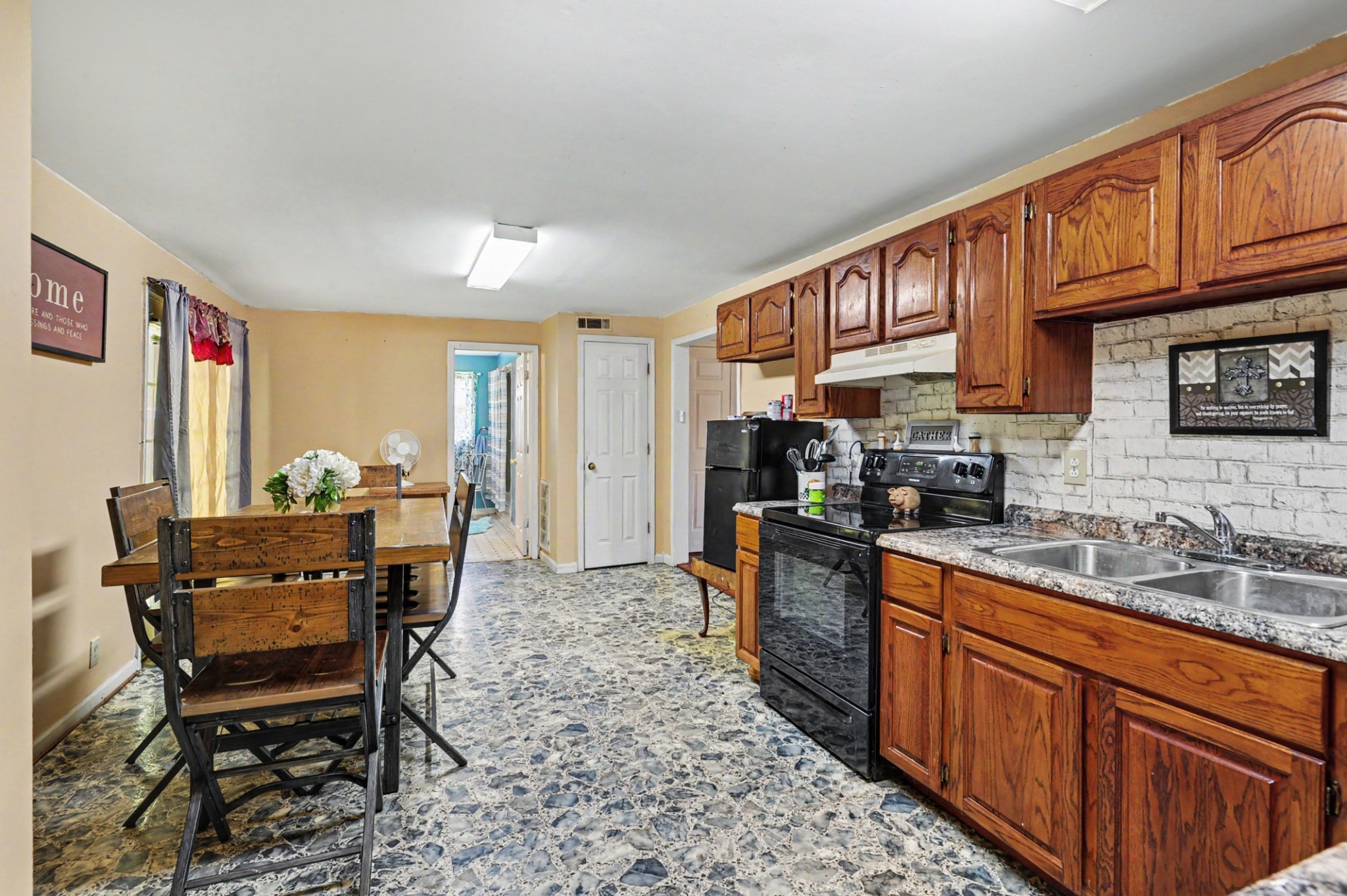 1241 Butler Bridge Road Portland, TN 37148 - Photo 8 of 15 a open kitchen with stainless steel appliances granite countertop a stove top oven a refrigerator a sink dishwasher and wooden cabinets with wooden floor