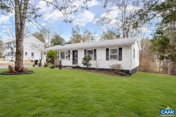 a view of a house with a backyard