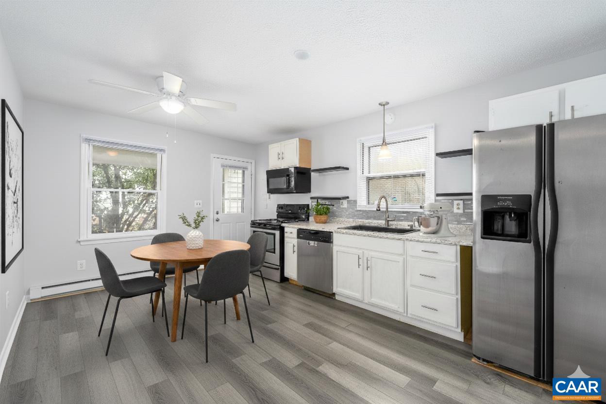 9 Pleasant View Terrace Palmyra, VA 22963 - Photo 3 of 34 a kitchen with stainless steel appliances granite countertop a dining table chairs refrigerator sink and cabinets
