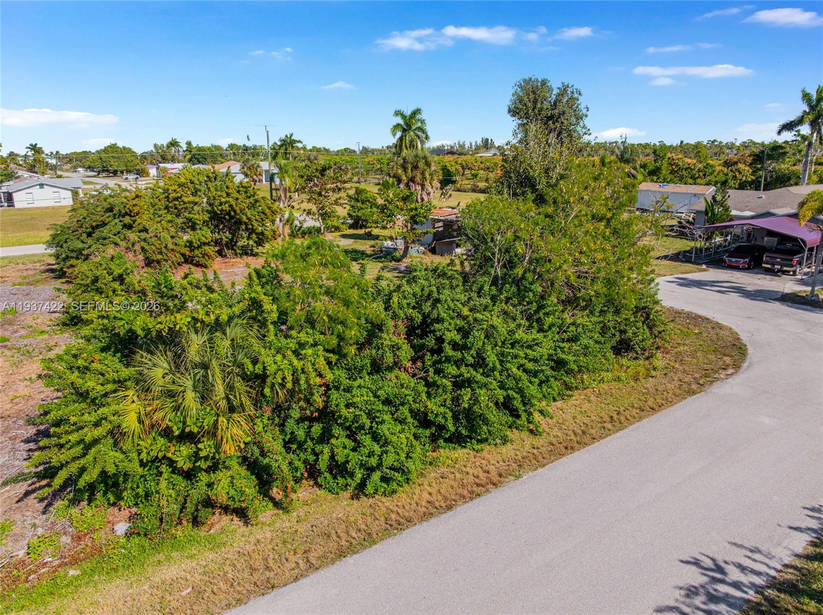 7324 Cobb Road Bokeelia, FL 33922 - Photo 15 of 24 a view of a garden with a building in the background