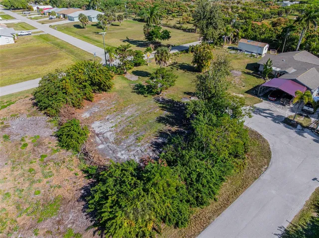 an aerial view of residential houses with outdoor space and lake view
