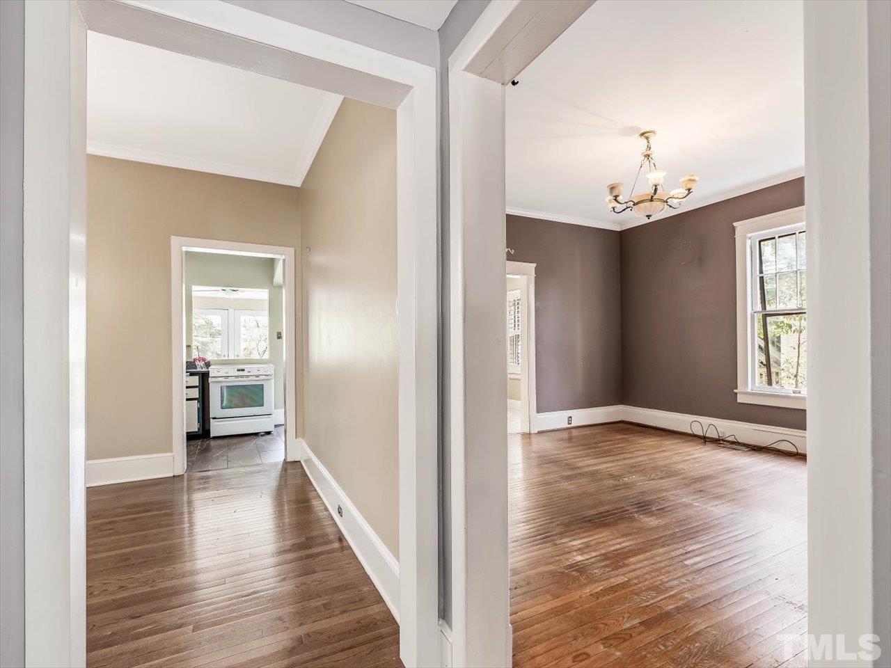 118 Hawthorne Road Raleigh, NC 27605 - Photo 12 of 42 a view of a hallway with wooden floor and a bathroom