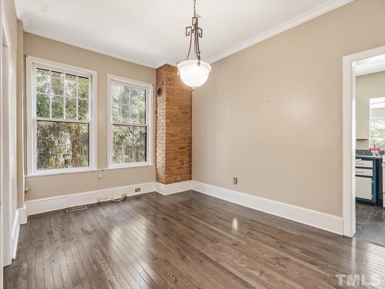 118 Hawthorne Road Raleigh, NC 27605 - Photo 13 of 42 a view of an empty room with wooden floor and a window