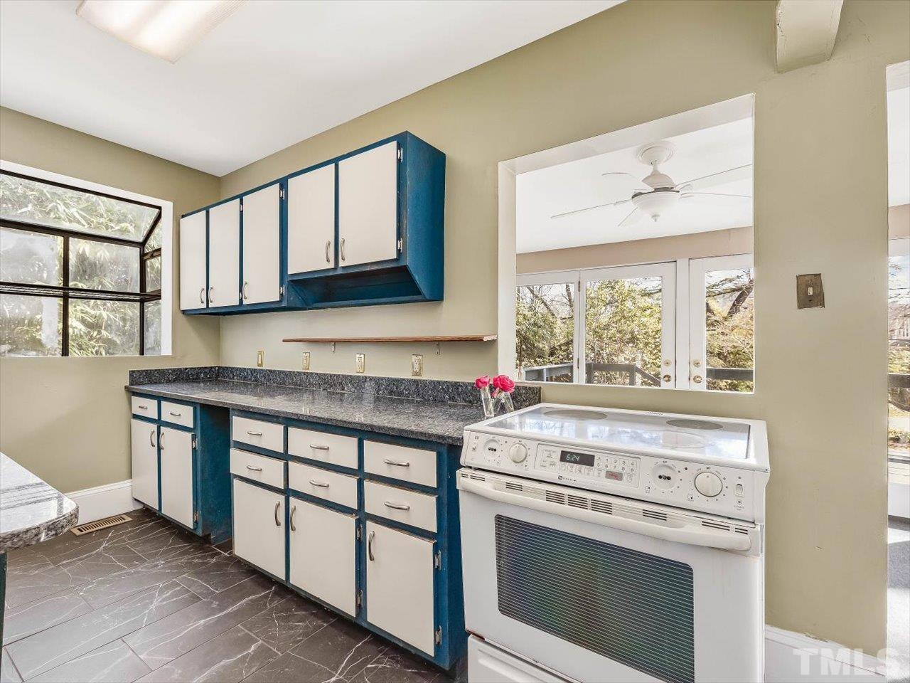 118 Hawthorne Road Raleigh, NC 27605 - Photo 18 of 42 a kitchen with stainless steel appliances granite countertop a stove a sink and a microwave
