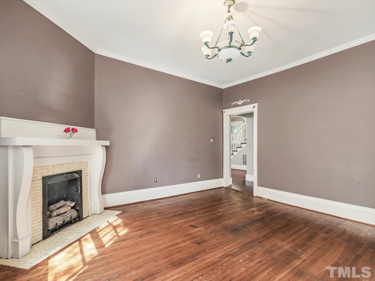 118 Hawthorne Road Raleigh, NC 27605 - Photo 23 of 42 a view of a livingroom with wooden floor and a fireplace