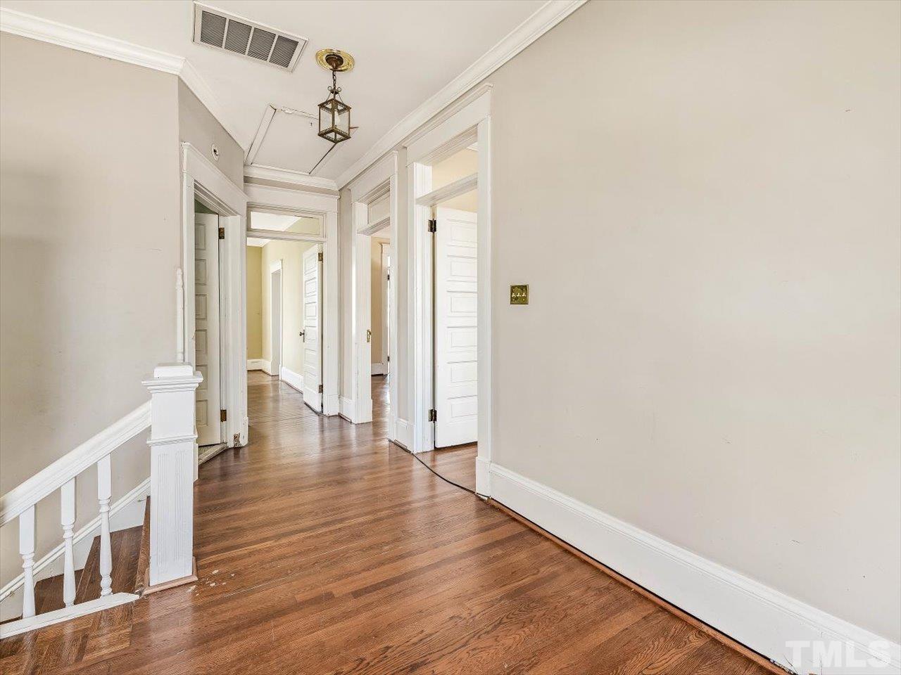 118 Hawthorne Road Raleigh, NC 27605 - Photo 27 of 42 a view of a hallway with wooden floor and staircase