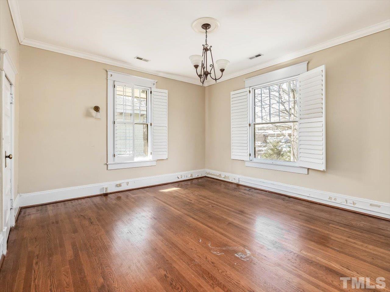 118 Hawthorne Road Raleigh, NC 27605 - Photo 28 of 42 a view of an empty room with wooden floor and a window