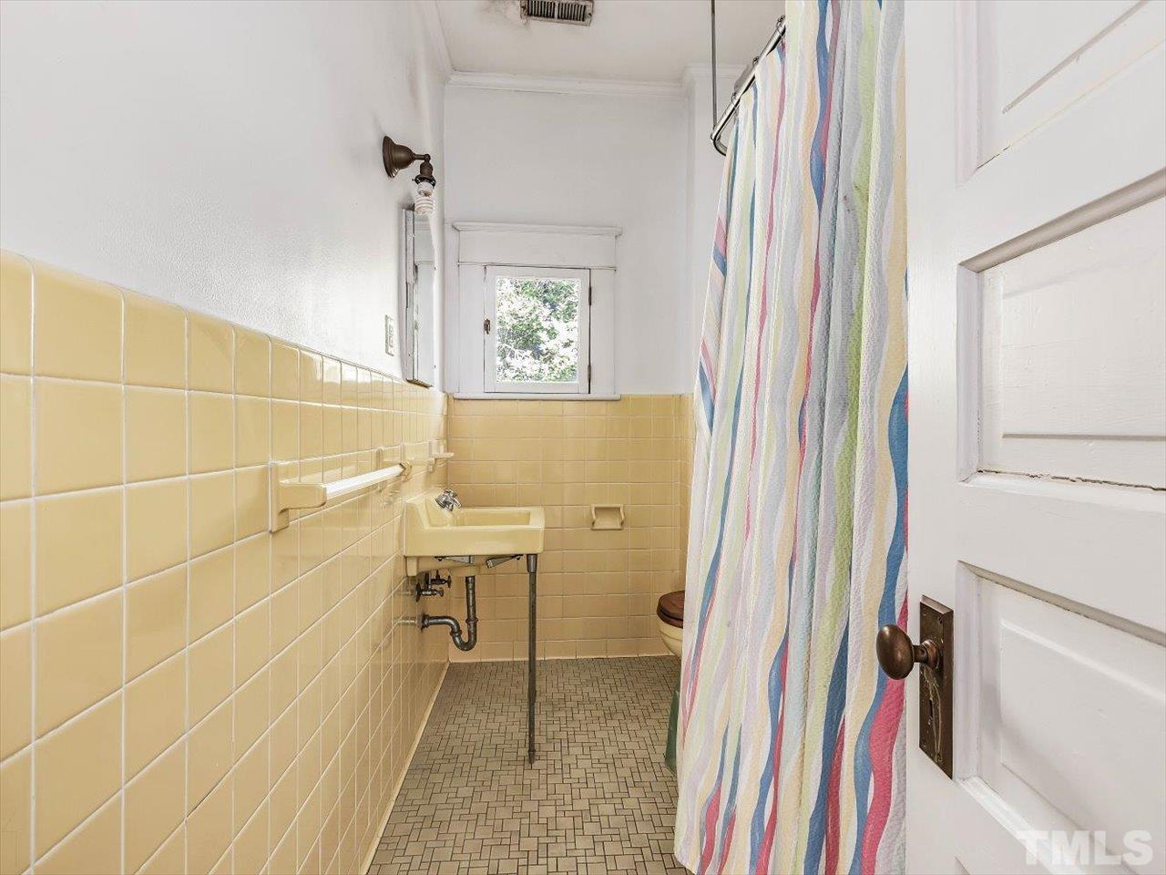 118 Hawthorne Road Raleigh, NC 27605 - Photo 29 of 42 a bathroom with a sink a toilet and a shower curtain