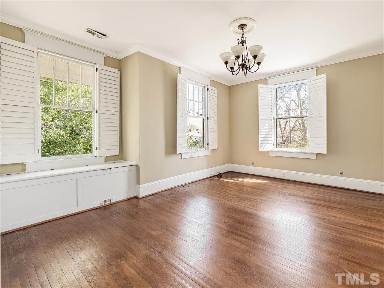 118 Hawthorne Road Raleigh, NC 27605 - Photo 30 of 42 a view of an empty room with wooden floor and a window