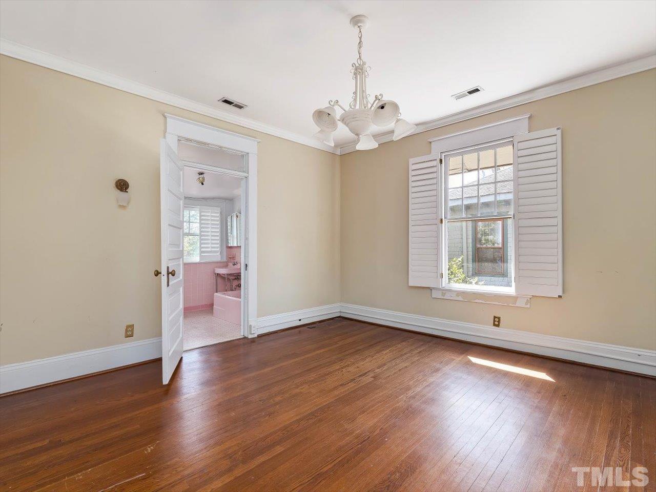 118 Hawthorne Road Raleigh, NC 27605 - Photo 33 of 42 a view of an empty room with wooden floor and a window