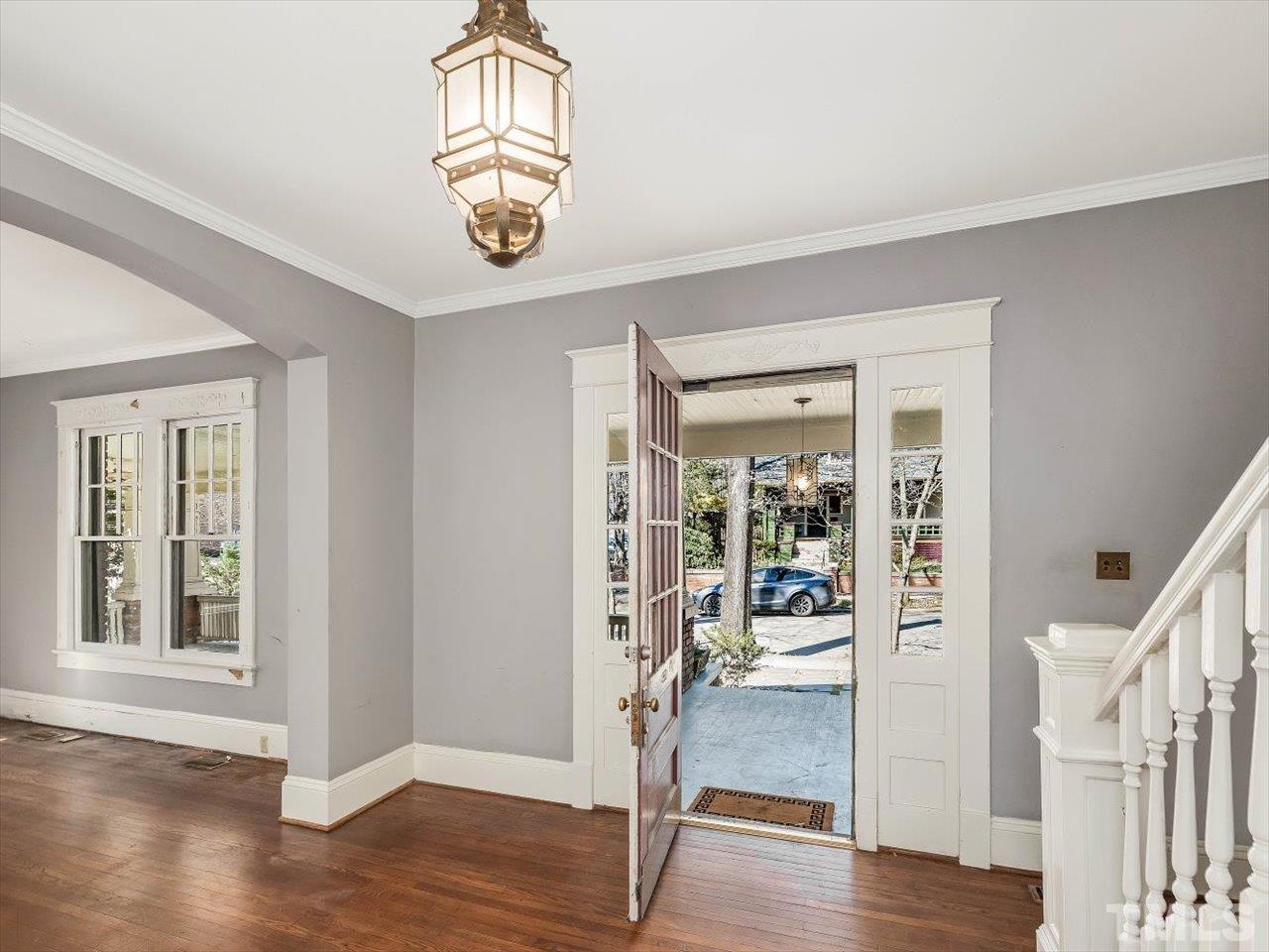 118 Hawthorne Road Raleigh, NC 27605 - Photo 6 of 42 a view of an empty room with wooden floor and a window
