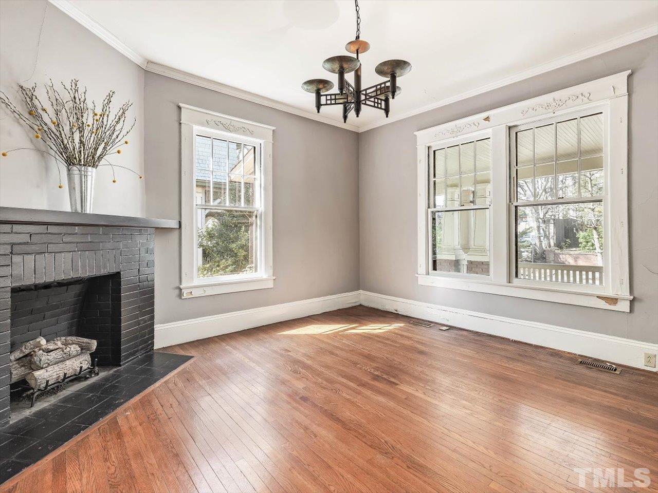 118 Hawthorne Road Raleigh, NC 27605 - Photo 10 of 42 a view of an empty room with a window and fireplace