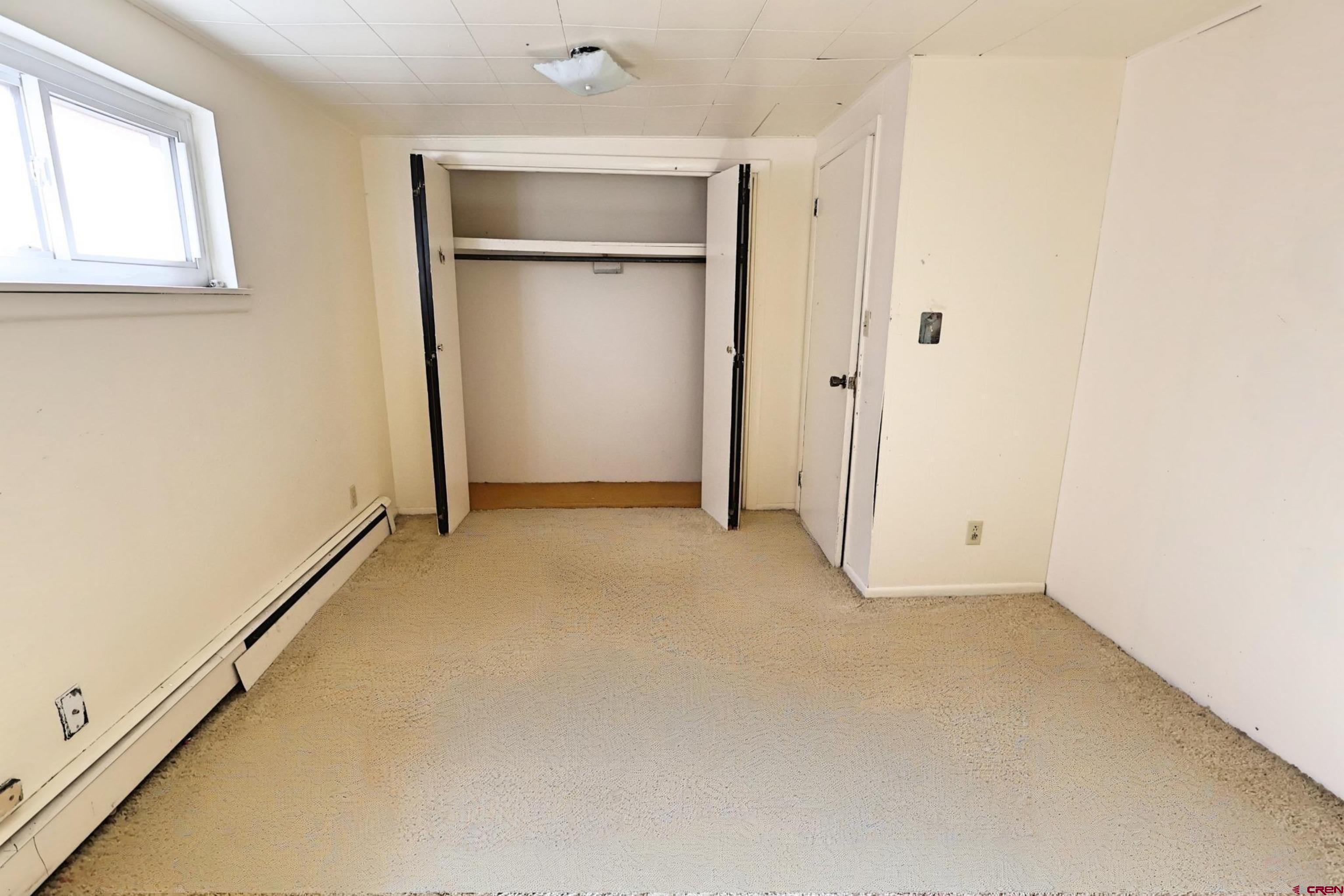 730 8th Street Alamosa, CO 81101 - Photo 12 of 29 an empty room with windows