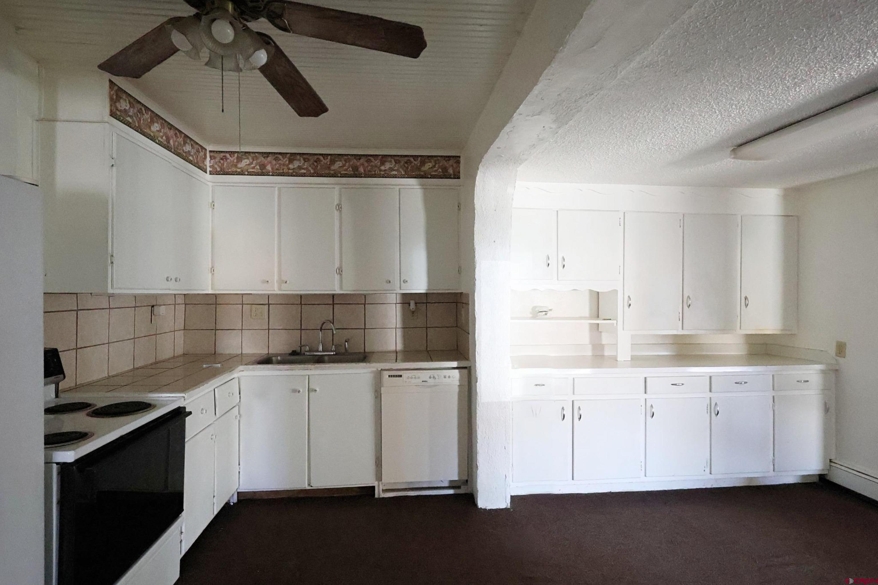 730 8th Street Alamosa, CO 81101 - Photo 20 of 29 a kitchen with granite countertop a sink stainless steel appliances and cabinets