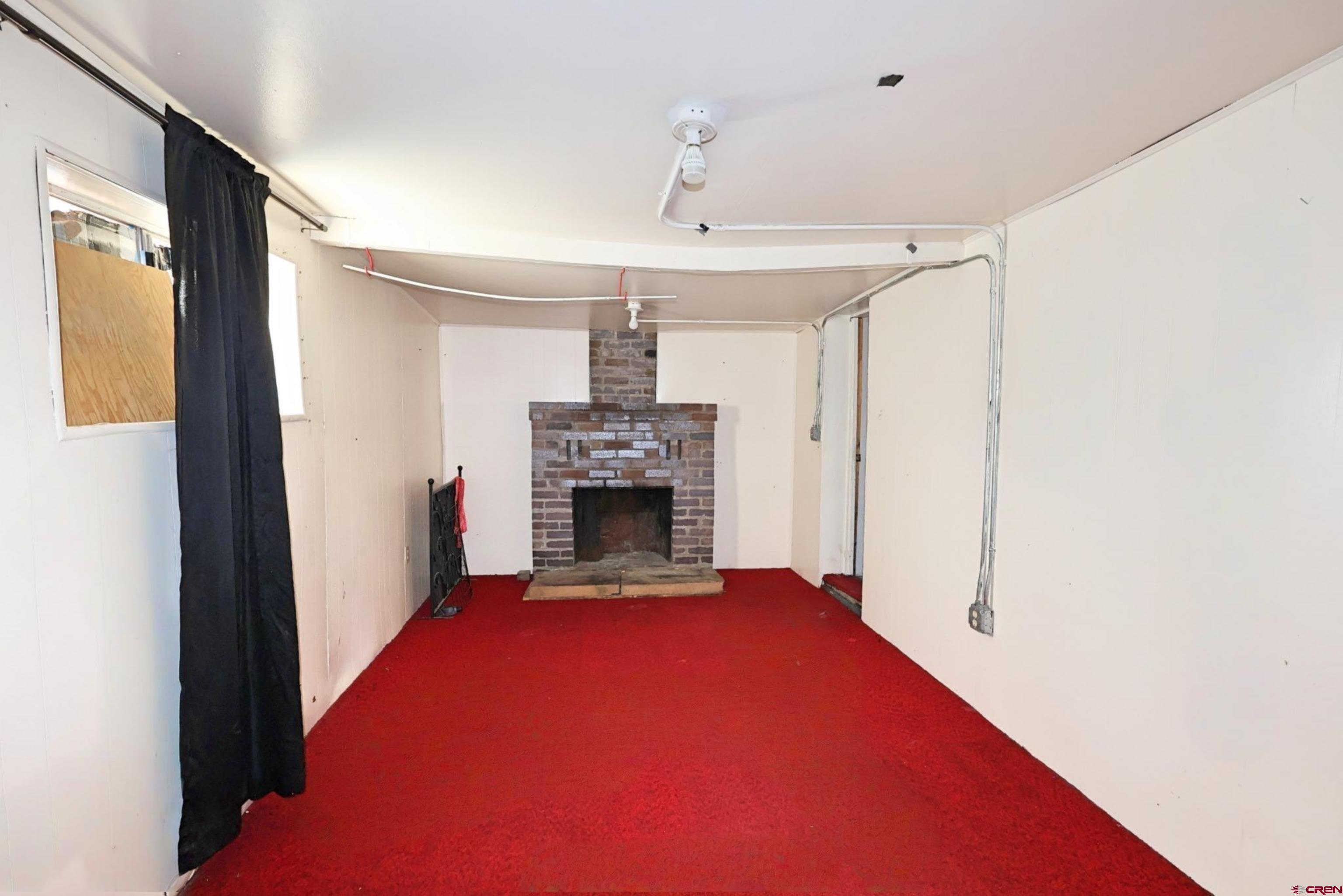 730 8th Street Alamosa, CO 81101 - Photo 6 of 29 a view of empty room with a fireplace