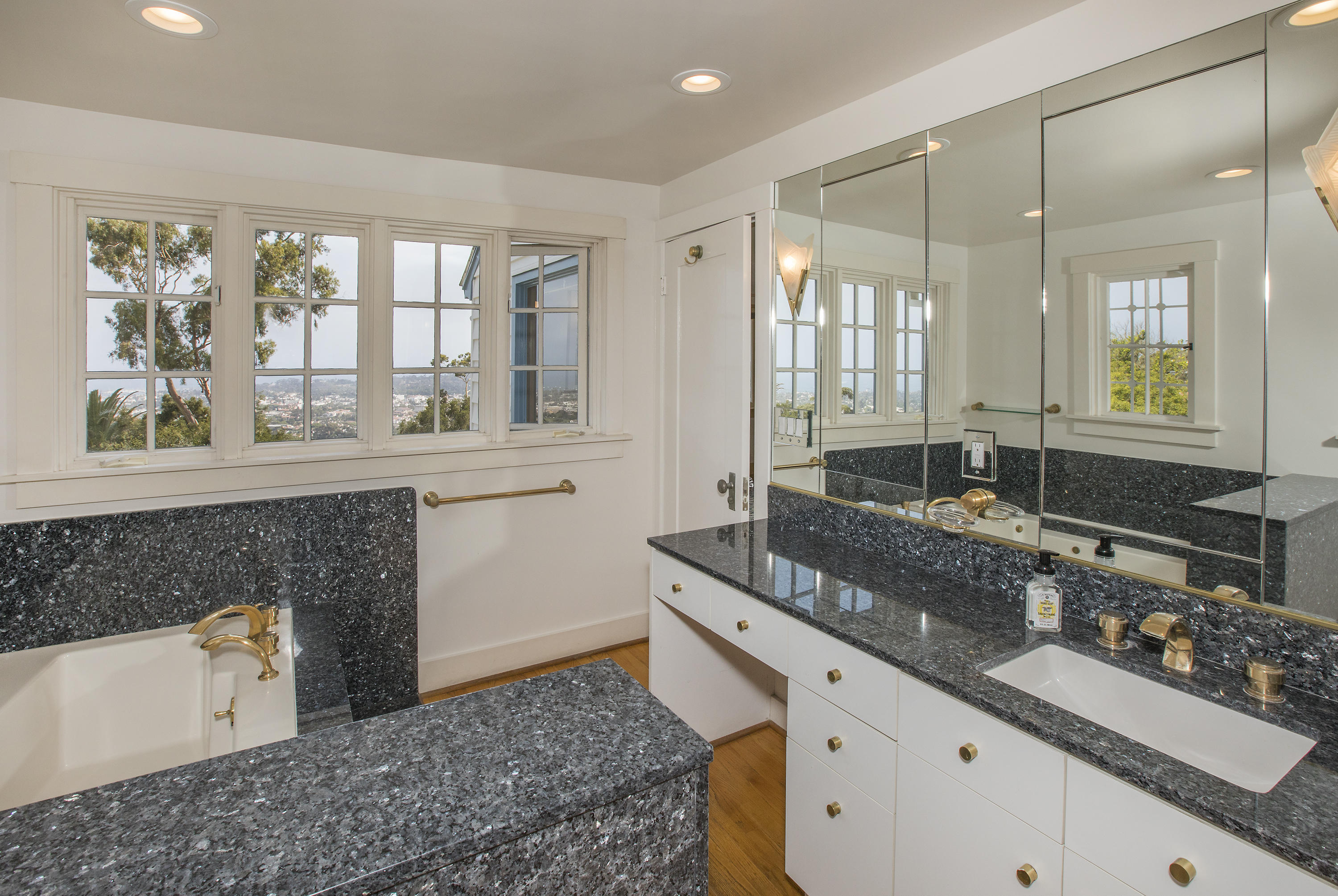 1415 Dover Road Santa Barbara, CA 93103 - Photo 22 of 40 a spacious bathroom with a granite countertop tub sink and mirror