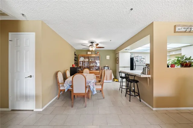 a dining room filled with furniture and a chandelier