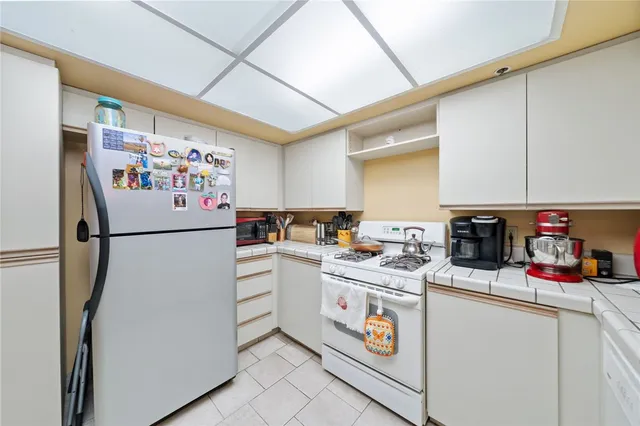 a white refrigerator freezer sitting in a kitchen