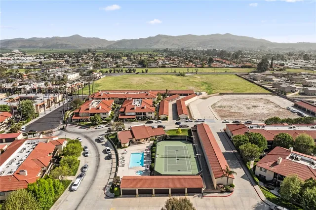 an aerial view of a house with swimming pool garden and patio