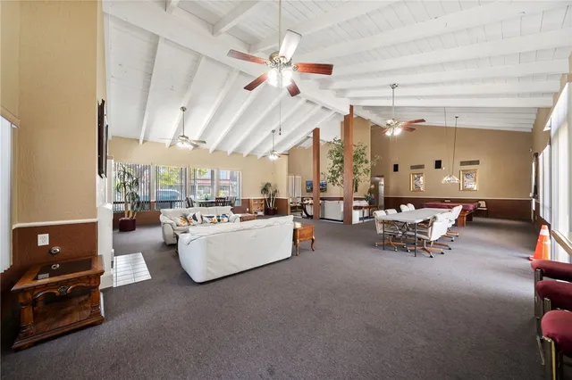 a view of a livingroom with furniture and a large window