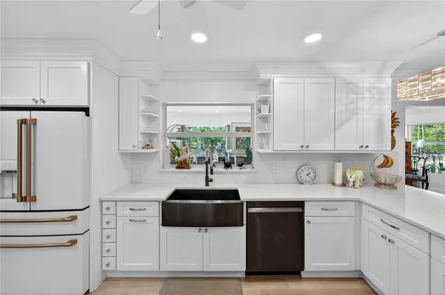 a kitchen with appliances a sink and cabinets