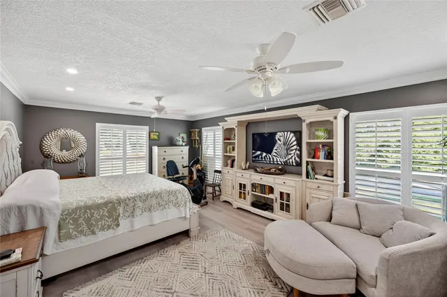 a living room with furniture a flat screen tv and a window