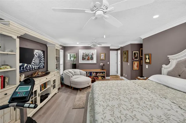 a bedroom with furniture and a flat screen tv