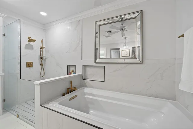 a bathroom with a tub a sink and a shower