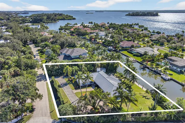 an aerial view of house with yard swimming pool and outdoor seating