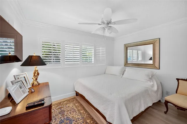 a bedroom with a bed and a window with chair