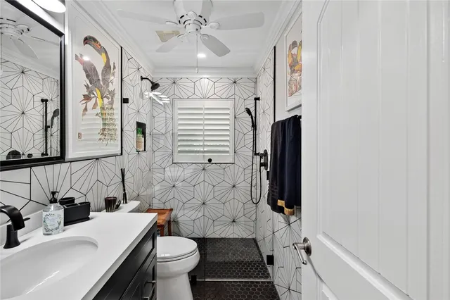 a bathroom with a sink a toilet a mirror and shower