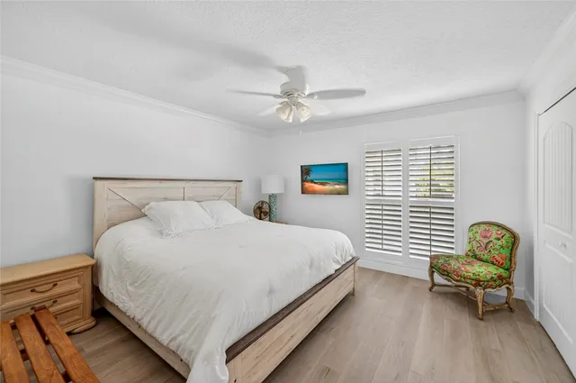 a bedroom with a bed dresser and a window