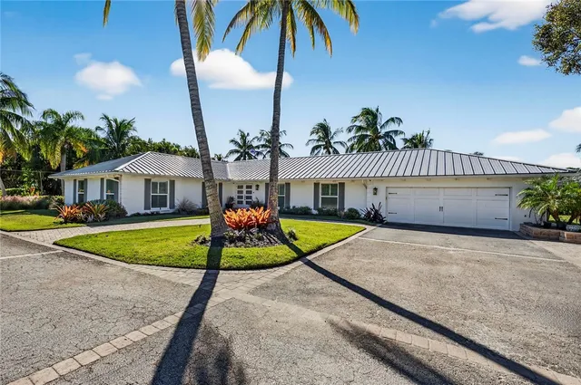a view of a house with swimming pool and a yard
