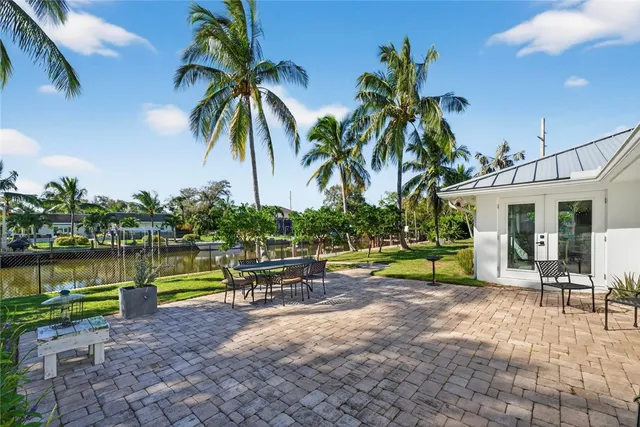 a row of palm trees in front of house