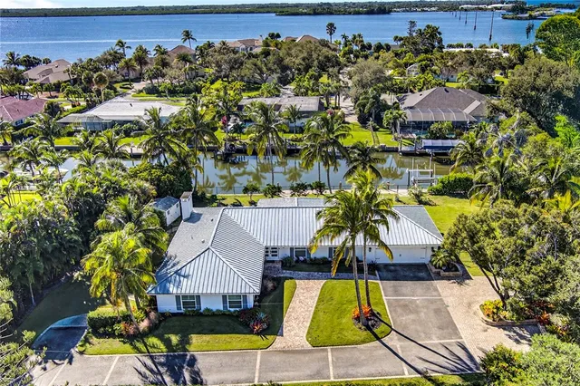 an aerial view of a house with a swimming pool patio and outdoor seating
