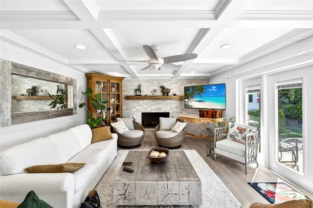 a living room with furniture large window and a fireplace