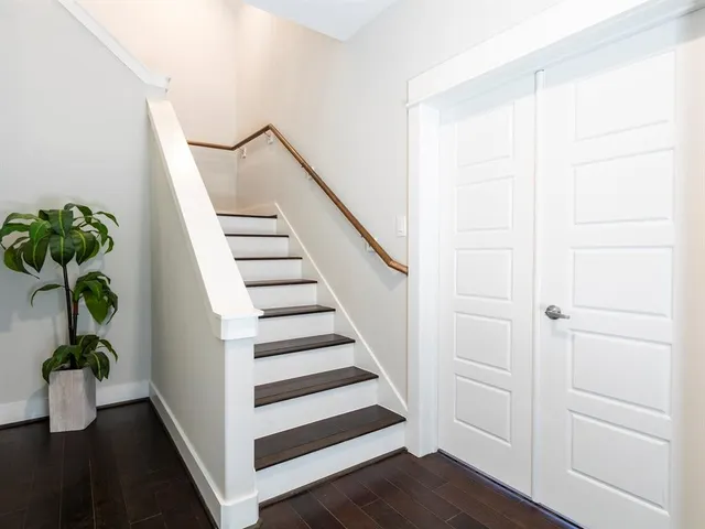 a view of entryway with wooden floor and stairs