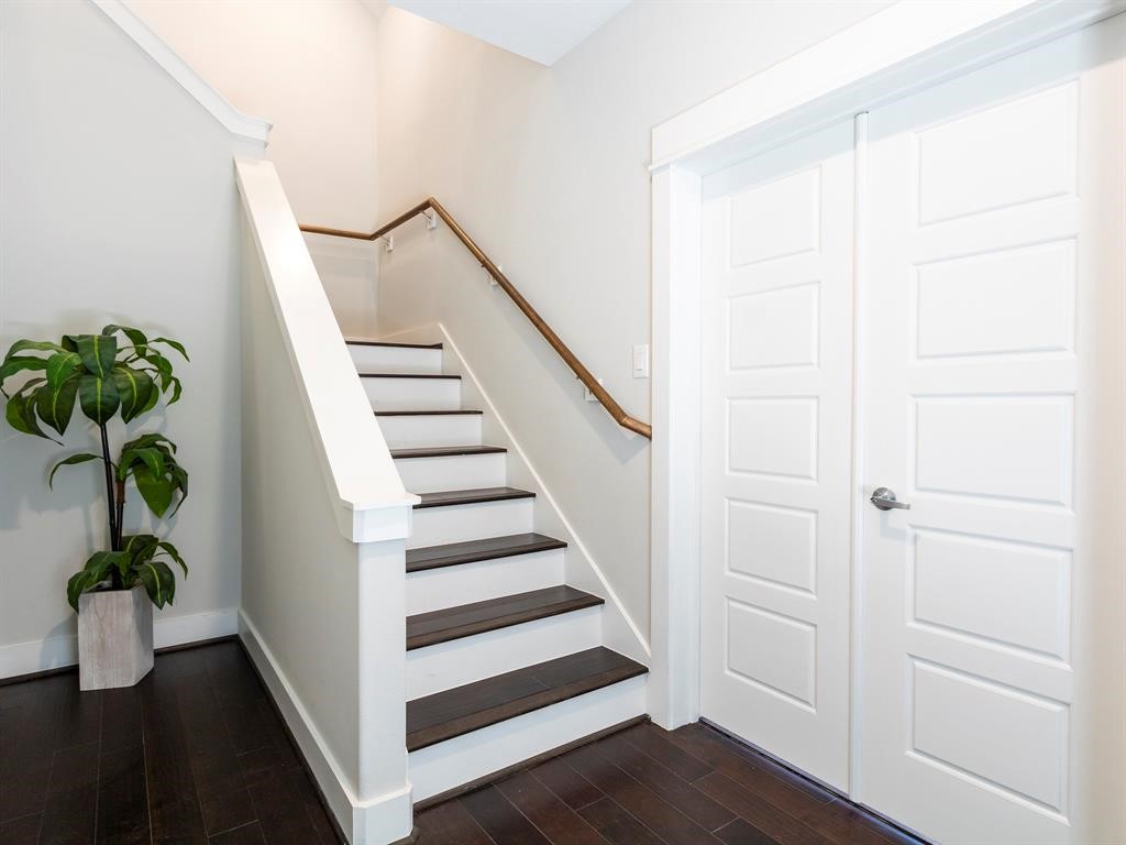 1027 West 24th Street Houston, TX 77008 - Photo 2 of 17 a view of entryway with wooden floor and stairs
