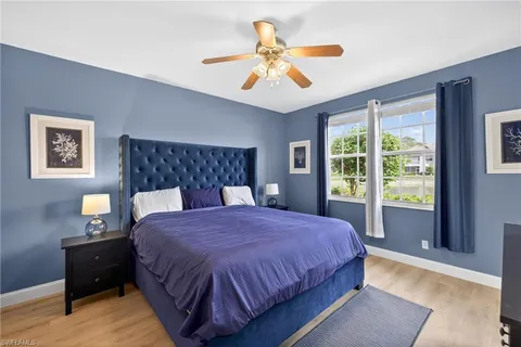a bedroom with a large bed and a window
