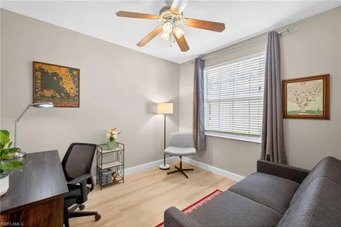a view of a livingroom with workspace and a window