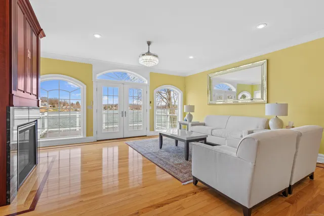 a living room with fireplace furniture and a large window