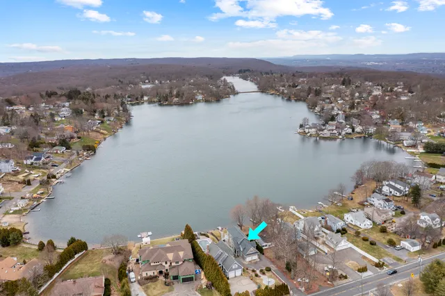 an aerial view of a house with a lake view